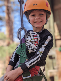 Young boy attached to a zipline